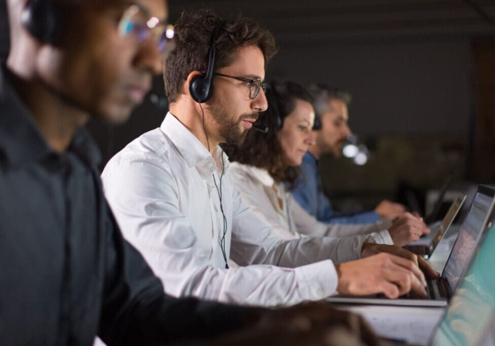 a group of people in their laptops